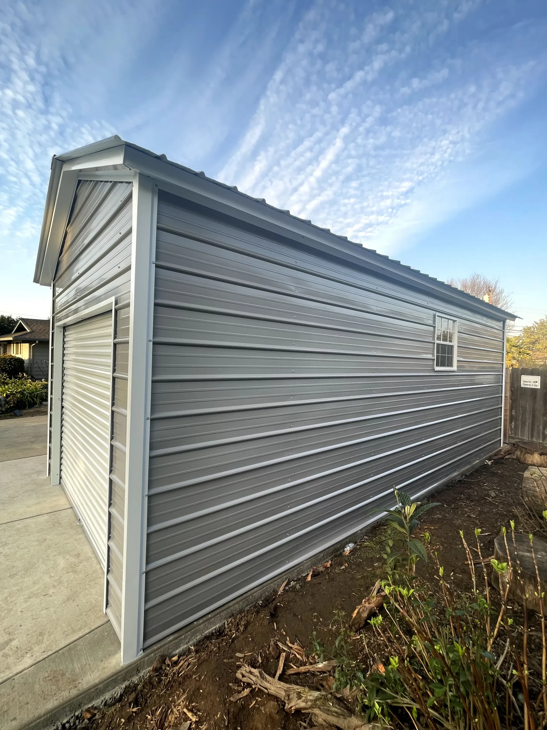 Pre-engineered galvanized steel residential metal buildings kit designed for quick assembly as an insulated backyard workshop and storage shed.