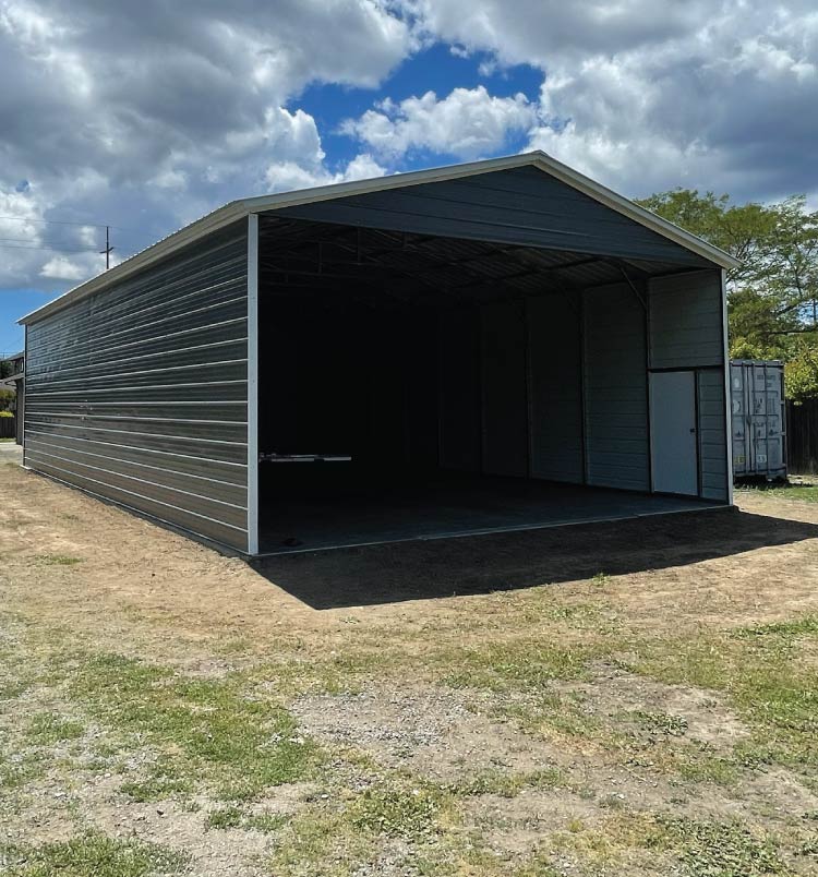 Affordable steel metal RV covers structure with an A-frame roof and anchor system, perfect for protecting campers and travel trailers from sun damage.